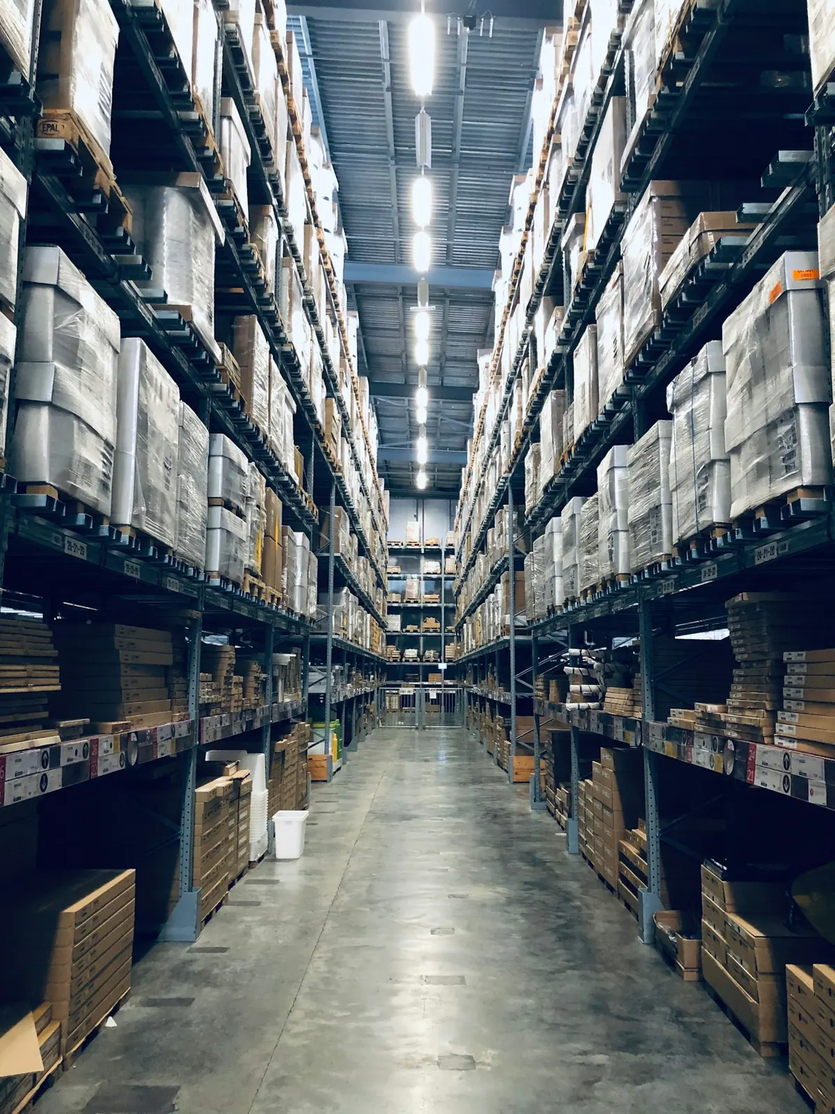 Warehouse aisle with racking stacked high on both sides